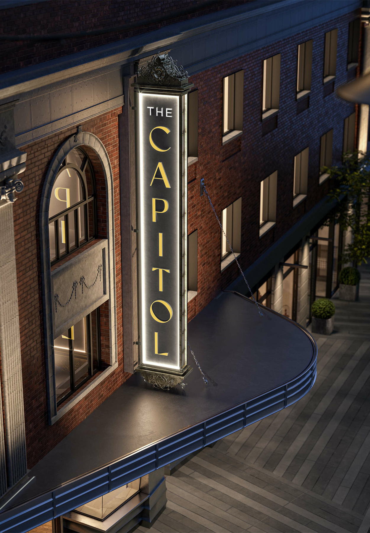 The original Capitol Theatre marquee, gold letters on the red brick heritage facade at dusk